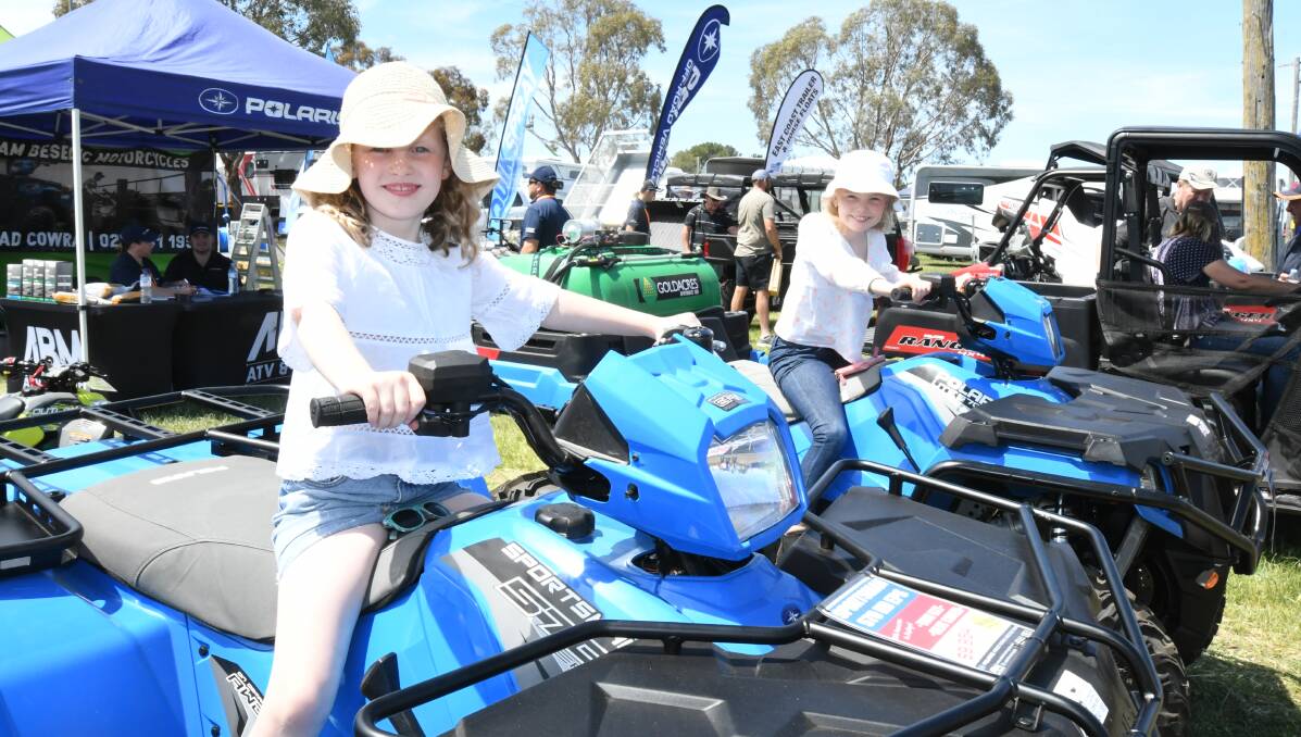 MACHINERY DISPLAY: Eliza and Audrey Peters on Polaris got to pretend they were riding four-wheelers at the field days. 