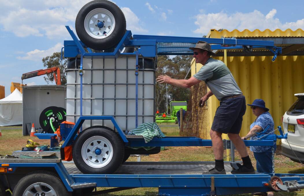 UNLOADING: Greg and Lyn Slade from Rural Outback Trailors travelled from Braidwood to sell fire fighting and water trailers.