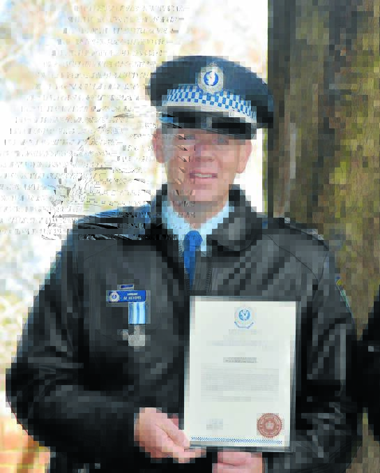 BRAVERY RECOGNITION: Sergeant Mark Hevers with the commissioners commendation and medal for courage he received at a NSW Police Force local area command medals and awards presentation in 2014.