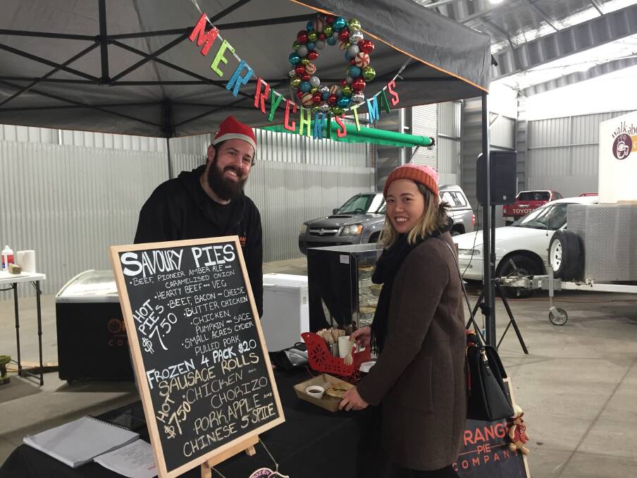 BUSY DAY: Ben Coster from Orange Pie Company with Michelle Parsonage who was visiting from Sydney at the Christmas in July farmers market.