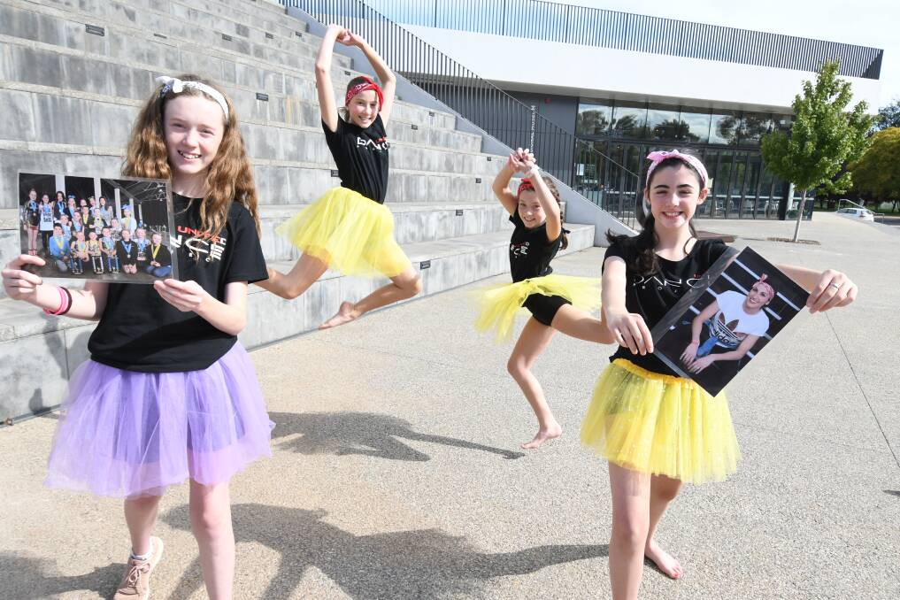 DREAM TO DANCE: Lyla Luxford holding a team photo, Clare Jadezak, Ally Luxford and Maddie Linsell-Ryan holding a picture of Steph Sandford in whose memory they are taking part in the relay. Photo: JUDE KEOGH