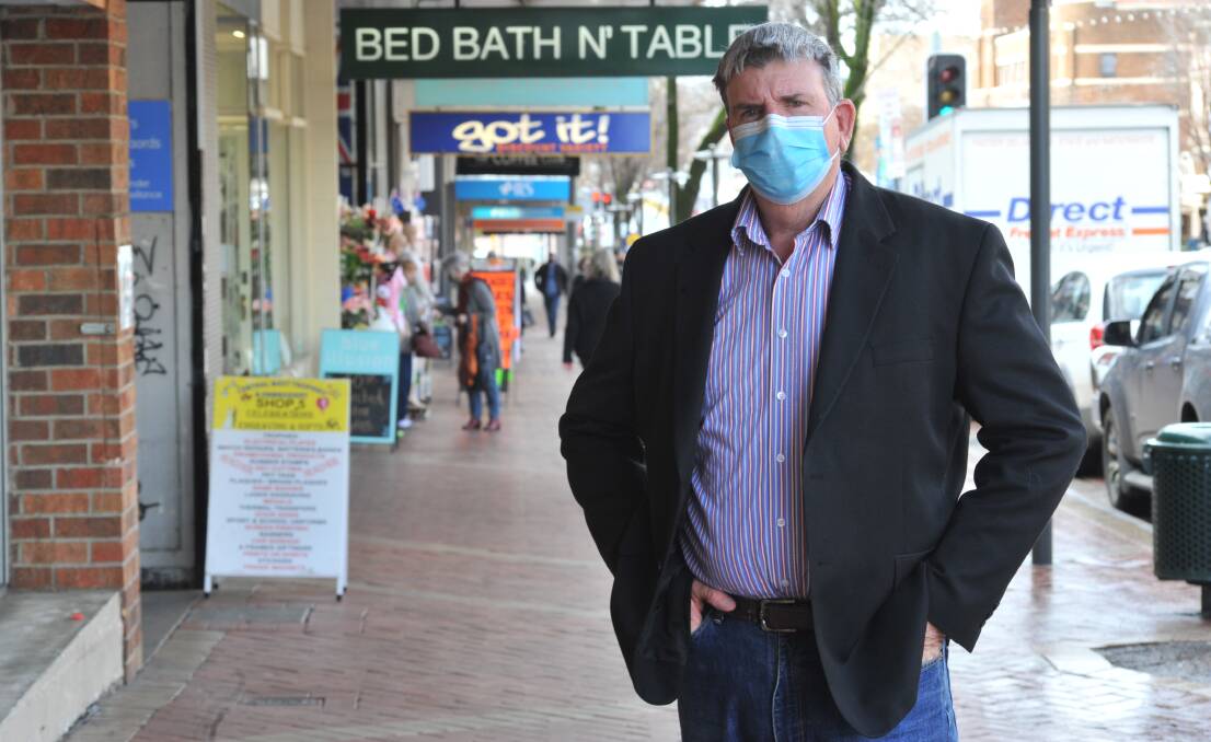 WARNING SIGNS: Councillor Glenn Taylor, with correctly placed sandwich boards in Summer Street, is urging businesses to be mindful of footpath safety. Photo: JUDE KEOGH