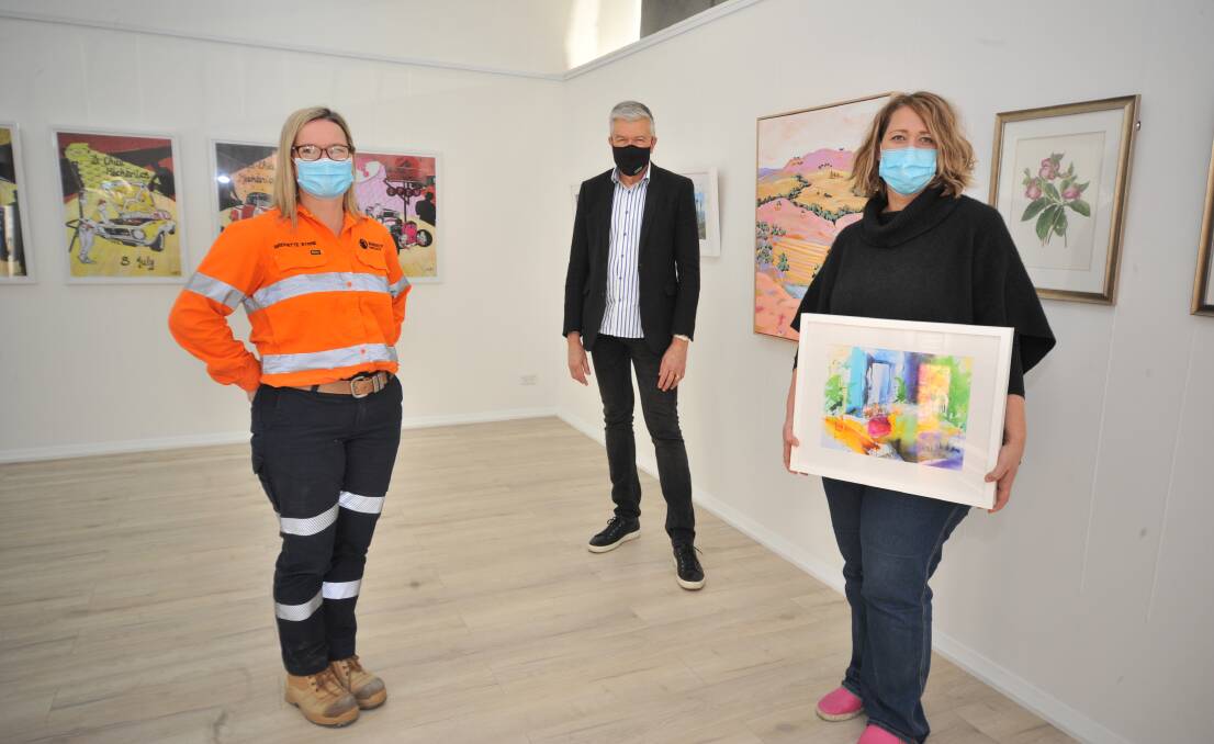 ECONOMY BOOST: Bridgette Byrne from Newcrest, Tony Cheney, with Peisley Street Gallery owner Leiarna Dunworth who is participating in the initiative. Photo: JUDE KEOGH