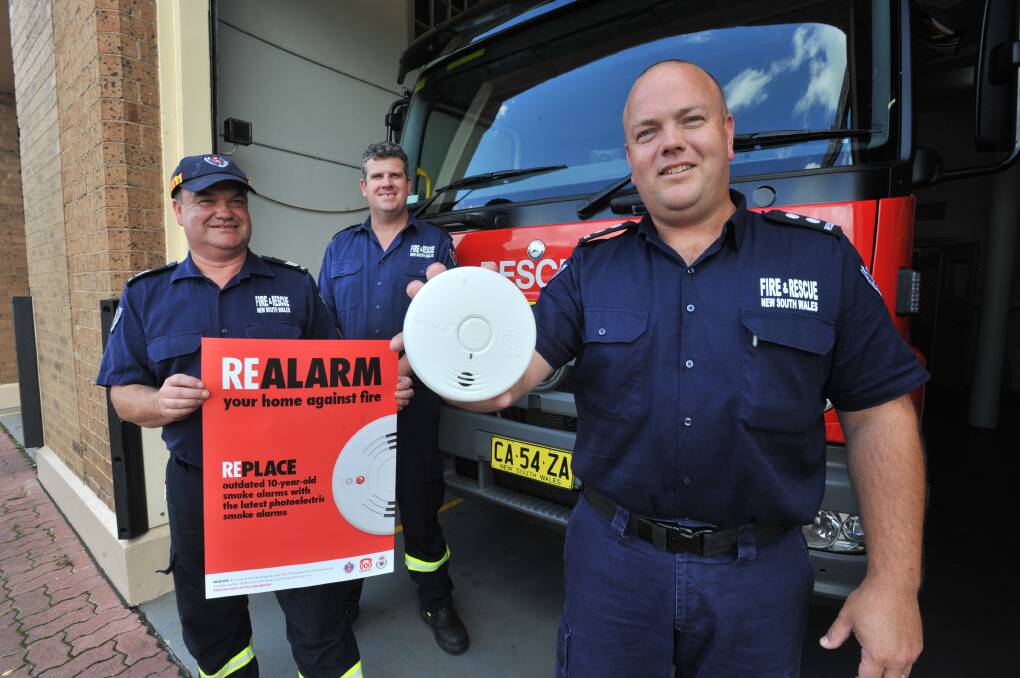 A FRIENDLY REMINDER: Phil Pedley, Mark Bell and Dane Philippe have asked people to check their smoke alarms this weekend. Photo: JUDE KEOGH