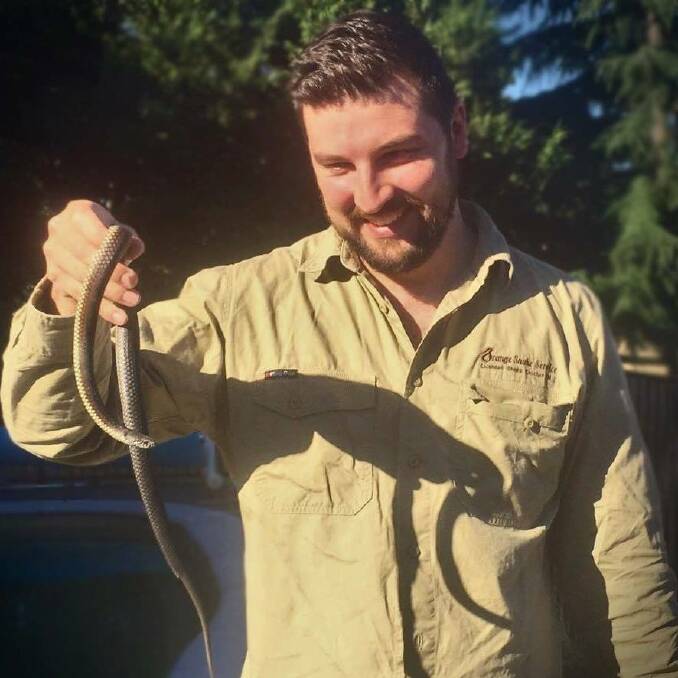SNAKE CATCHER: Orange Snake Services snake catcher Jake Hansen, with an adult snake, said there are misconceptions about baby snakes. Photo: SUPPLIED