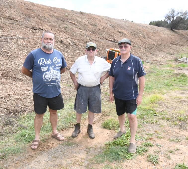 EXPOSED: Residents Joe Maric, Kevin Smith and Jim New said they were not informed before Orange City Council removed shrubs that screened light and noise from the Northern Distributor Road. Photo: JUDE KEOGH