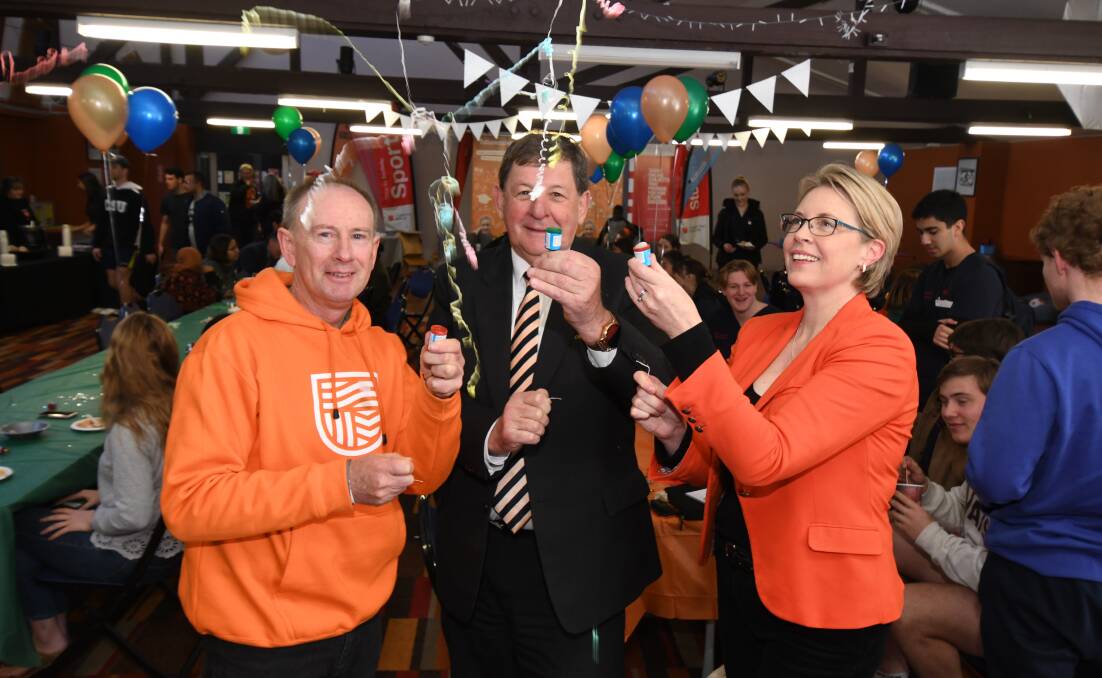 PARTY TIME: CSU chief financial officer Paul Dowler, Orange mayor Reg Kidd and CSU external engagement director Julia Andrews celebrate. Photo: JUDE KEOGH