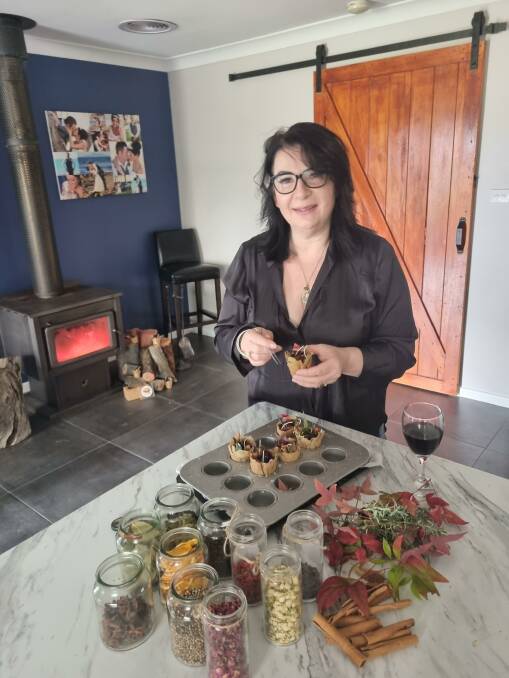 HOME BUSINESS: Candi Oliva making her sustainable Pyromania.botanical fire lighters which are decorated and scented with natural flowers, leaves and spices. Photo: SUPPLIED