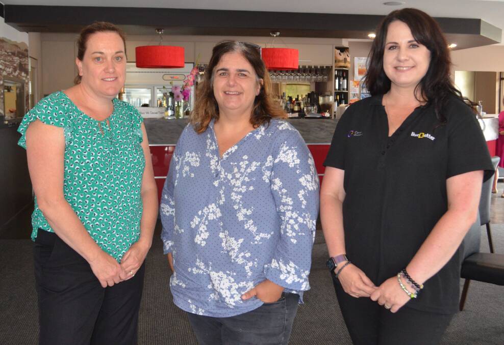 MERRY CHRISTMAS: Carer Gateway peer support partners Gabrielle McDonell and Louise Fossilo with carer Julie Jackson (centre) at the Christmas morning tea.