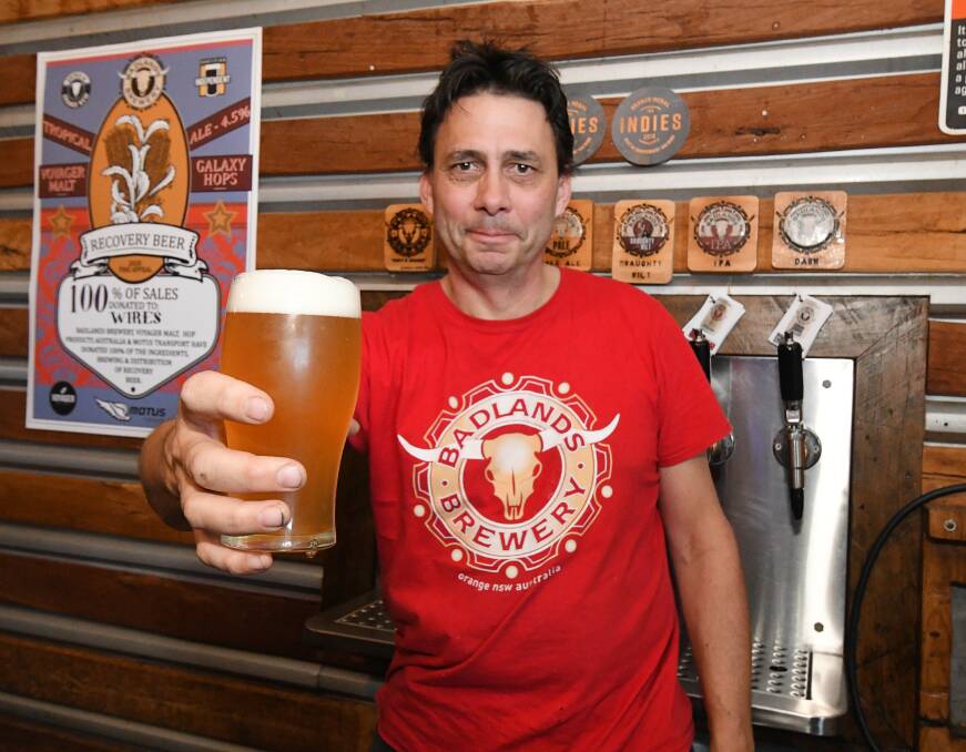 CHEERS: Badlands Brewery owner Jon Shiner with a glass of the Recovery Beer he brewed for bushfire fundraising. Photo: JUDE KEOGH