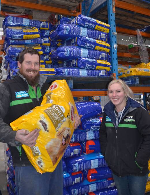 KIBBLE CATERerS: Mullion Produce Pets and Saddlery employees Adam Dane and Steph Medcalf are supporting Cause for Paws. Photo: TANYA MARSCHKE 0712tmpetfood1