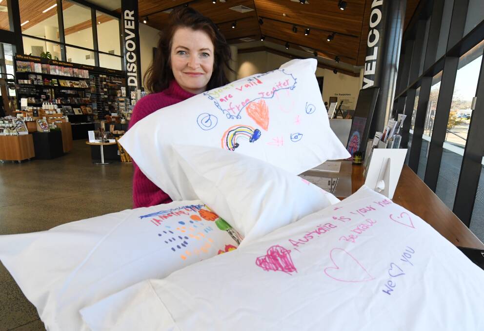 DREAMS FOR FREEDOM: Mums4Refugees convenor Anna Noonan with some of the pillowcases that will be given to refugee children. Photo: JUDE KEOGH