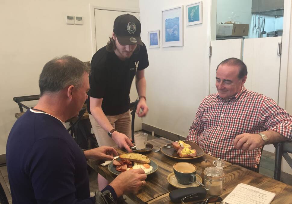 BUSY EASTER: Brady Goodman serves brunch to Nick Kobocs and Derek Maloney at The Burrow on Monday morning.