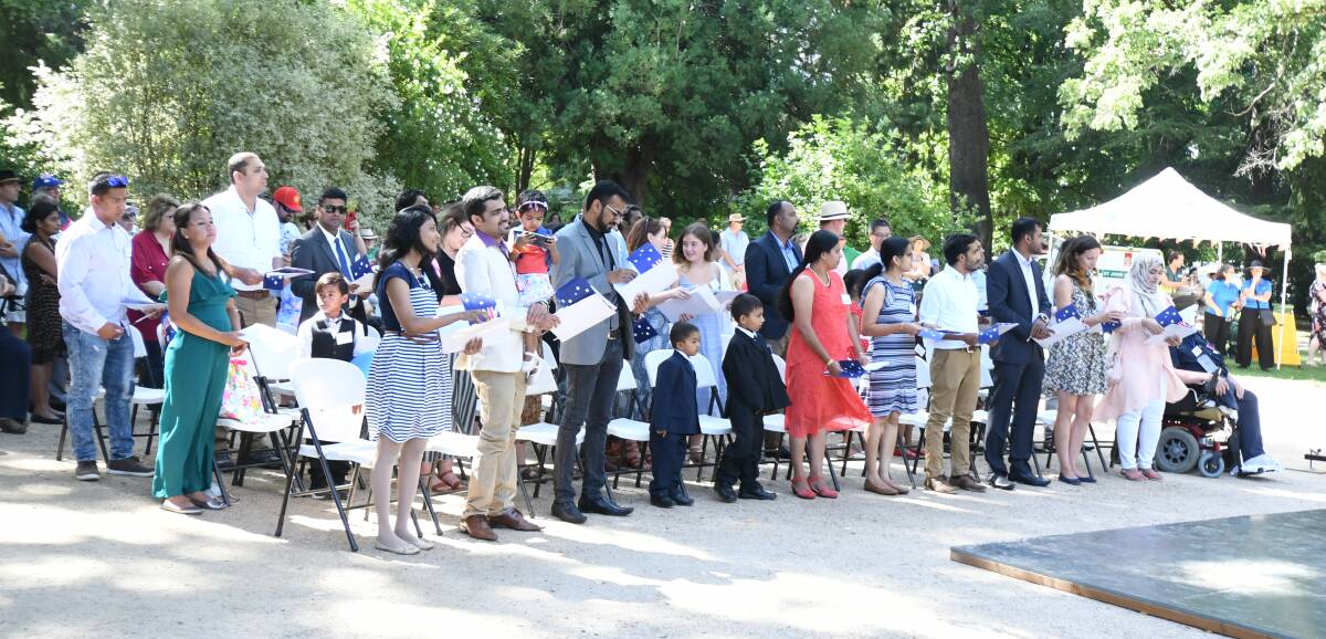 NEW CITIZENS: Thirty-six new citizens reciting the pledge at Cook Park on Saturday. Photo: CARLA FREEDMAN