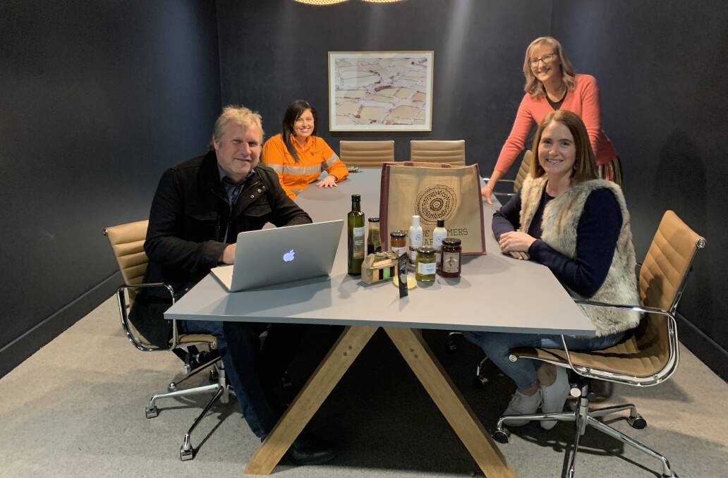 ONLINE SHOPPING: Peter Mills from Mills Web Design, Melissa OBrien from Newcrest Mining and Holly Manning and Christine Chiarella from Manning PR discuss the Click and Collect option for the Orange Farmers Market website. Photo: SUPPLIED