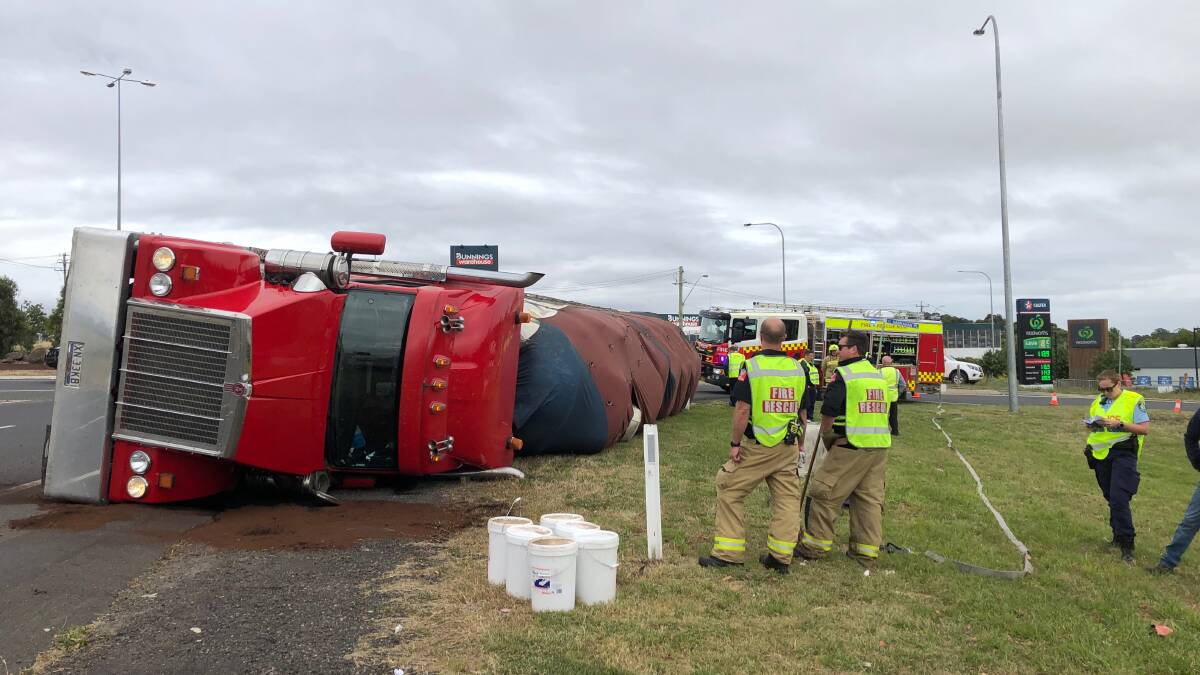 ROLL OVER: Firefighters and police at the scene of the truck rollover. Photo: ALANA CALVERT