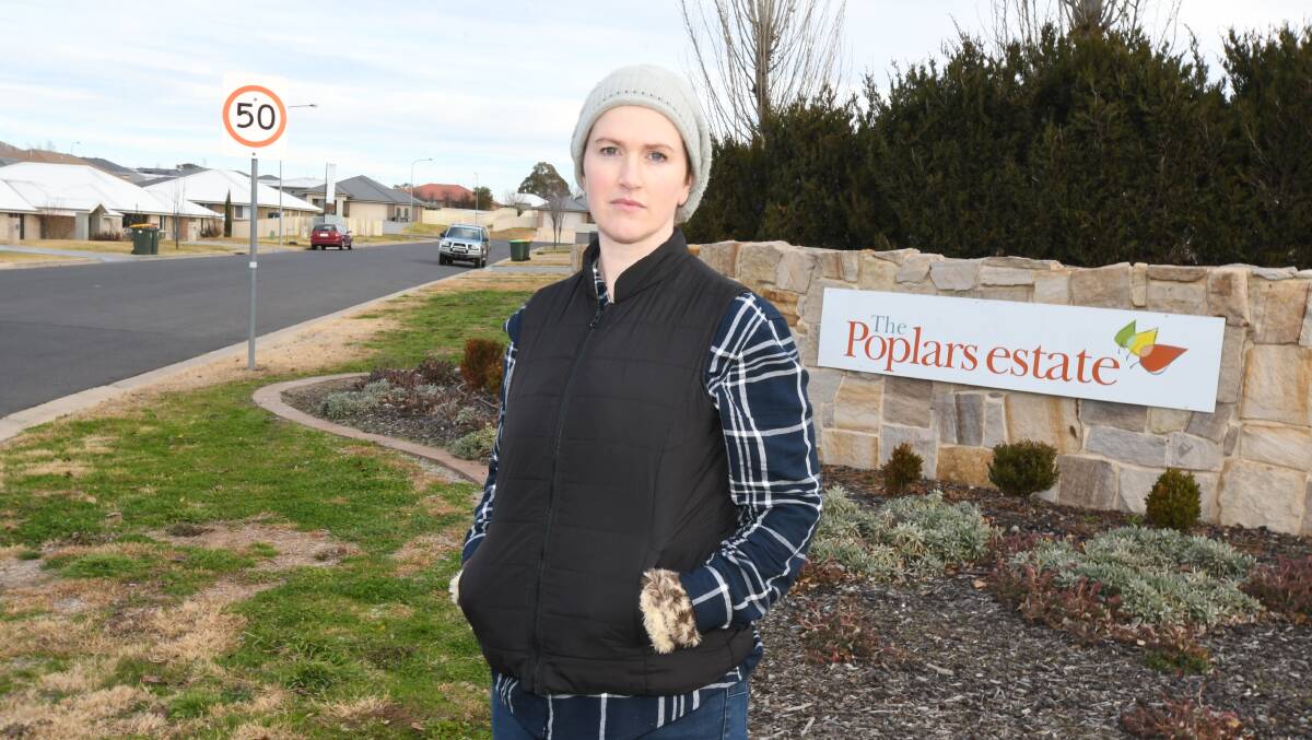 NOT SAFE: Melanie McDonell at the corner of the Escort Way and Poplars Drive where she is calling for footpaths to be installed. Photo: JUDE KEOGH
