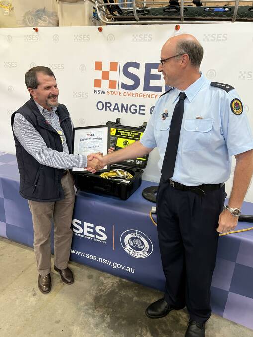 DONATION: Bruce Smith, President, Rotary Orange Daybreak, Inspector Robert Stevens, NSW State Emergency Service, Orange City Unit.. Photo: SUPPLIED