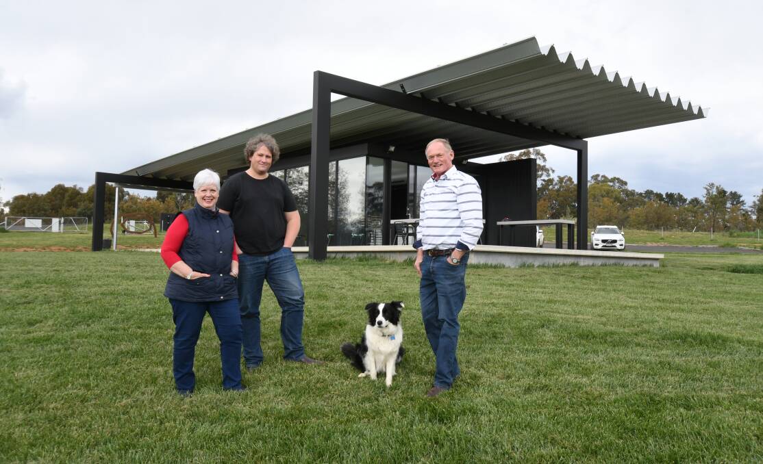 WINNING DESIGN: Montoro Wines owners Jennifer and Bob Derrick with architect David Sutherland (centre) and Bailey. Photo: JUDE KEOGH.