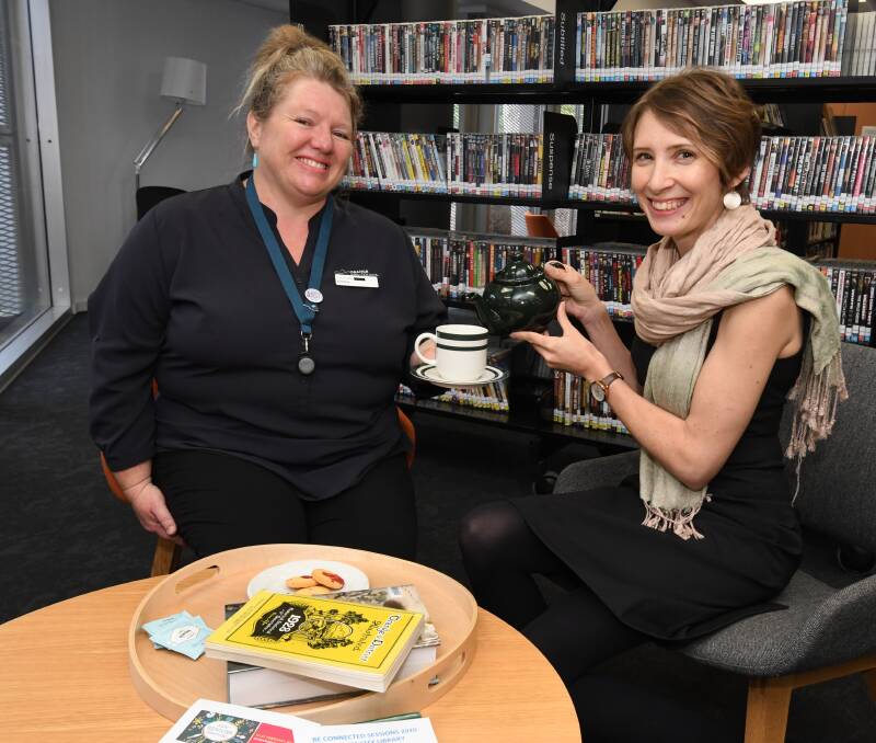 CHEERS: Emma Flemming and Bek Salmon at Orange City Library, where a seniors morning tea will be held. Photo: JUDE KEOGH