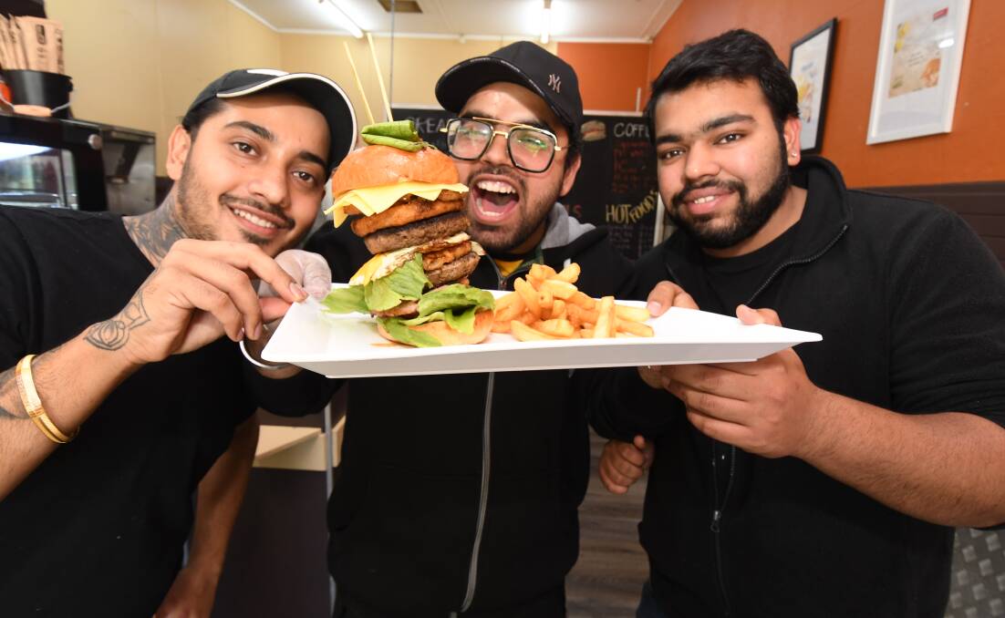 TUCK IN: Gurmeet Soni, Guri Singh, Ak Goyal opened Bad Burgers at the Alpine Store. Photo: JUDE KEOGH