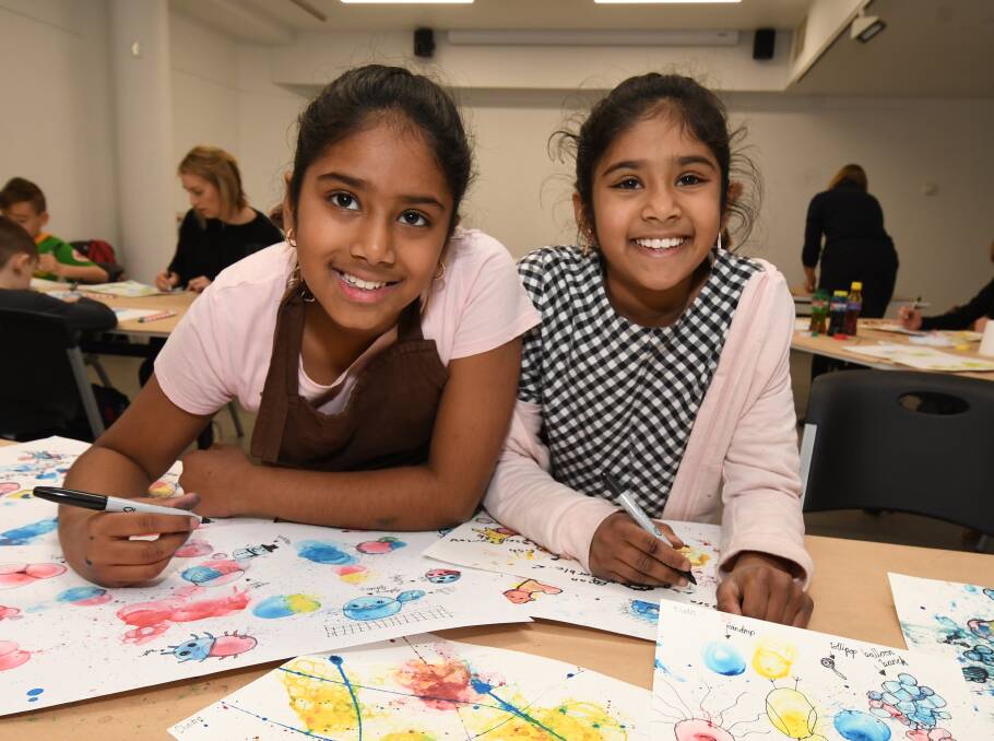 BRIGHT IDEAS: Chaitra and Sahasra Avirneni made colourful artworks at a bubble painting workshop at Orange Regional Gallery on Wednesday. Photo: JUDE KEOGH