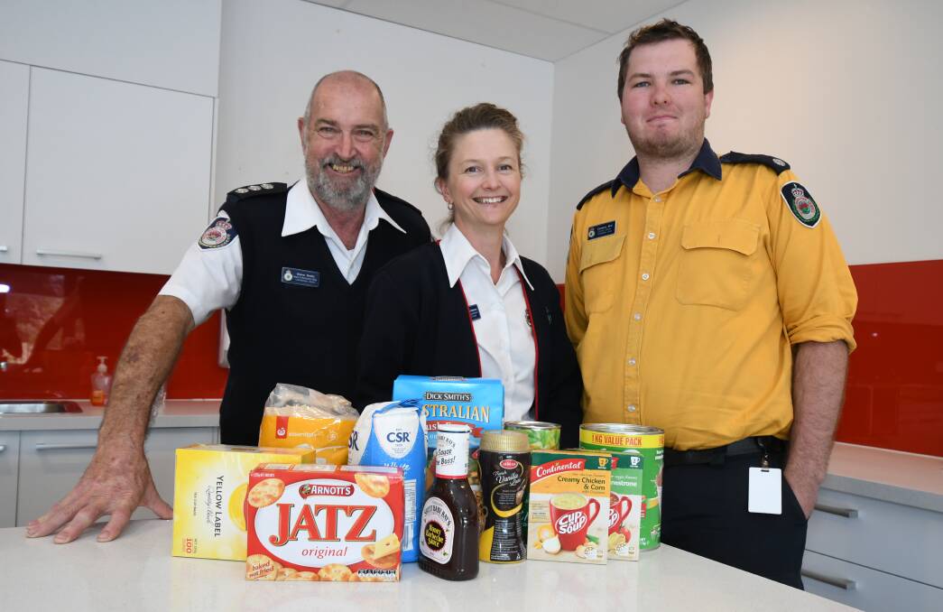 FOOD COLLECTION: Steve Smith Jasmyne Bootsma and Cameran Bird from the Canobolas Zone Rural Fire Service are taking part in the emergency services' Feed a Farmer campaign. Photo: JUDE KEOGH
