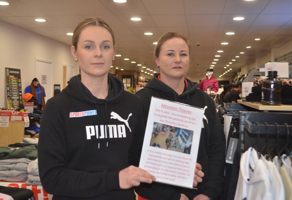 CRACKING DOWN: Sportspower Orange employee Jess Darley and assistant store manager Louise Littlefield with a warning to potential thieves. 