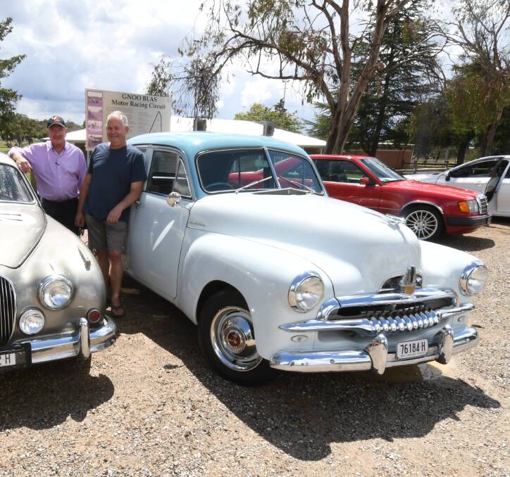 MOURNING: Graham Barrett and Ray Hallett with his 1954 FJ Holden Special. Photo: JUDE KEOGH
