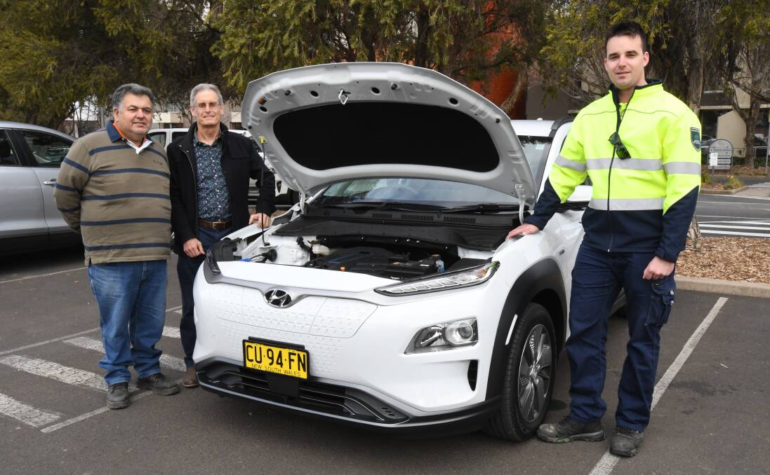 ELECTRIC FEEL: Orange City councillors Mario Previtera and Stephen Nugent with Lachlan Davis at the launch of the council's first electric cars. Photo: JUDE KEOGH 0726jkcar1