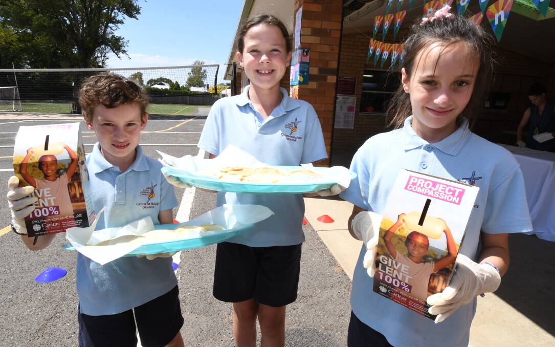 PANCAKE DAY: Catherine McAuley Catholic Primary School students Eamon Franklyn, Heidi Plokstys, Lini Qumivutia made pancakes for Shrove Tuesday, which preceded the first day of Lent leading to Easter. Photo: JUDE KEOGH