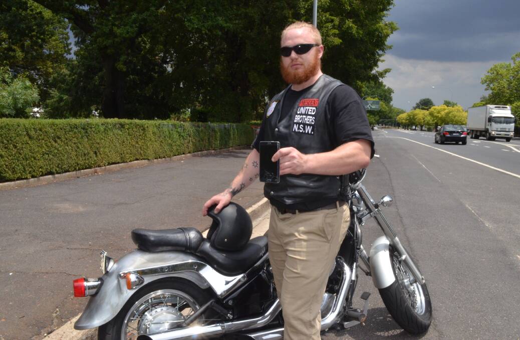 DAMAGE CAUSED: President of the United Brothers of Australia charity motorcycle club Jarrod Murphy said his phone was damaged as was a mirror, brakes and indicator on his motorbike after his group was attacked at Lake Canobolas on Australia Day. 