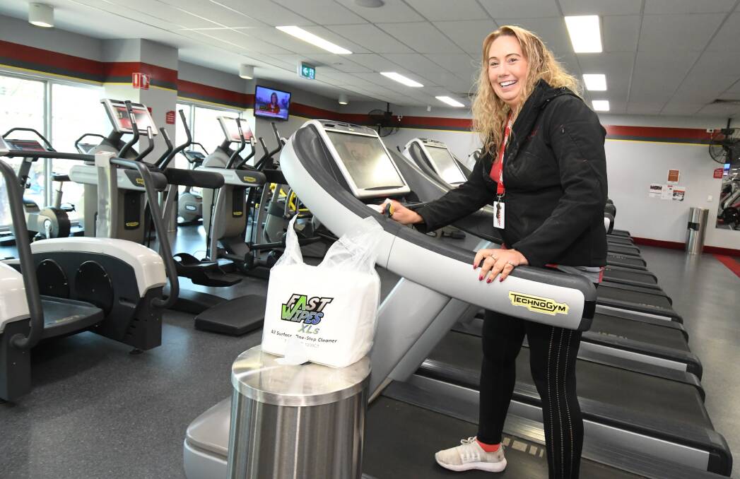 EXTRA CLEANING: Snap Fitness manager Tanya Chapman is regularly cleaning exercise machines. Photo: JUDE KEOGH