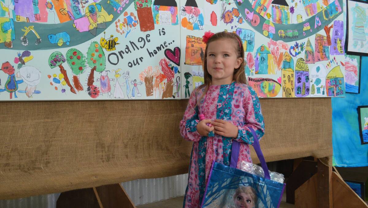 CREATIVE: Ellie Thompson with the Trinity Preschool artwork that she contributed to. Photos: TANYA MARSCHKE