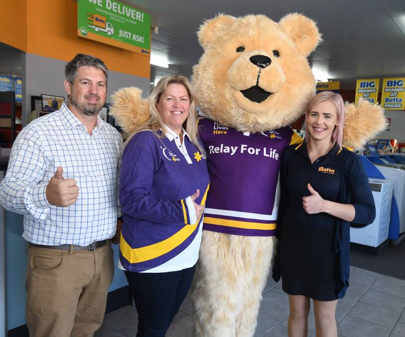 WINNER: Caner Council community relations coordinator Brendon Argyle, raffle winner Donna Nicholas, Dougal Bear and Clare Smith from Weily's Betta Home Living. Photo: JUDE KEOGH