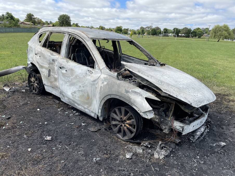 BURNT: Car destroyed by fire at Glenro Oval. Photo: JUDE KEOGH