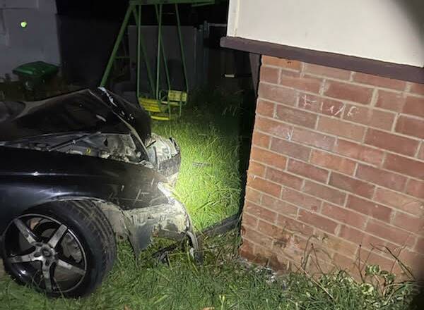 CRUMPLED: The car sustained significant front-end damage after crashing into the front corner of a house. Photo: FIRE AND RESCUE NSW ORANGE