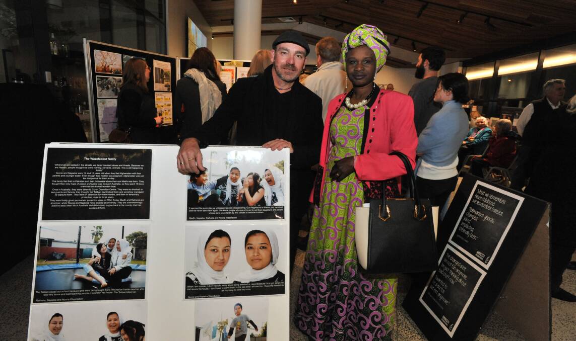 THROUGH THE LENS: Amnesty International community organiser Bede Carmody and guest speaker Sayeda Eumeiz at the Refugee Week photographic exhibition opening. 