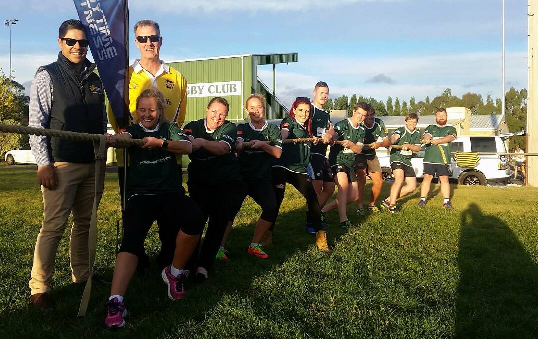 THIS MEANS WAR: The Cancer Council's Ricky Puata and Wes Vane along with members of Orange Emus Rugby Club ahead of the Relay for Life tug-of-war.