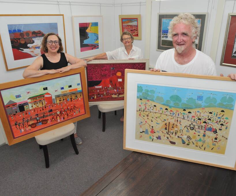 PICTURESQUE: Colour City Creatives publicity officer Jolanta Nejman, member Bev Duncan and president Phil Salmon prepare for the Outback and Downunder Australian Landscapes Exhibition. Photo: JUDE KEOGH 0203jkart1