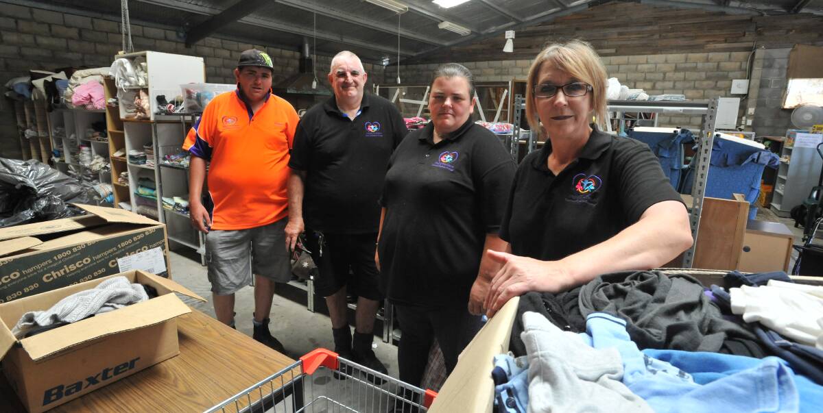 BAD TIMING: Pay It Forward Community Shed volunteers Nathan Hargraves, Greg Ferguson, Theresa Hargraves and Karlie Irwin ahead of Saturday's garage sale. PHOTO: Jude Keogh