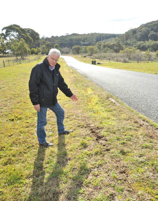 FED UP: Clifton Grove resident John Pullen has found five dead kangaroos within the same 150-metre stretch of road in the past 12 months. Photo: JUDE KEOGH 0805jkroos1