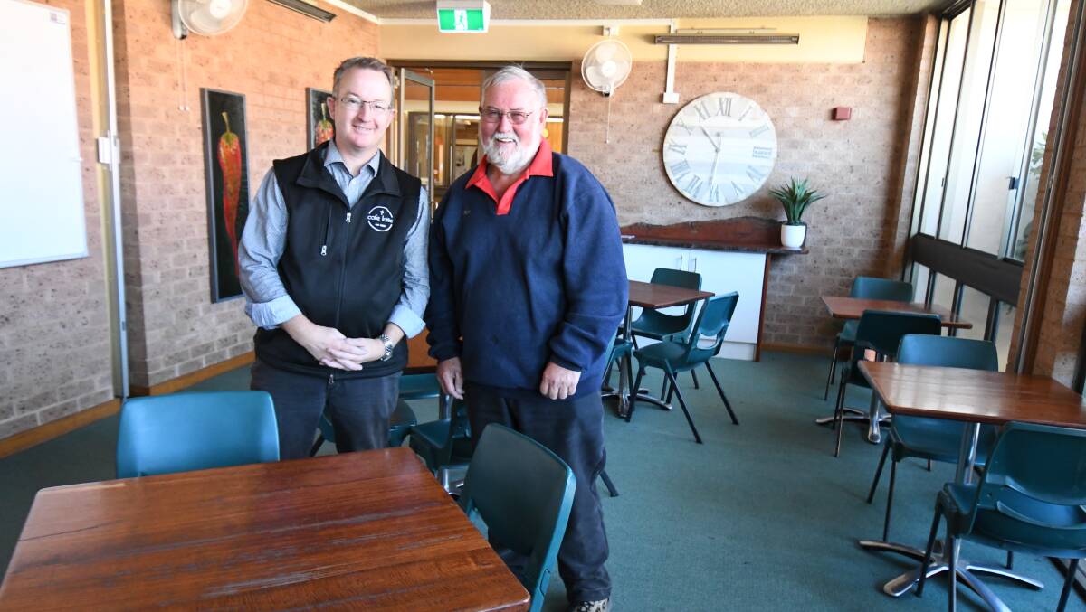 COFFEE'S UP: Cafe Latte's Aaron Wright with Orange Uniting Church's council chair Bob Nash at the pop-up venue on Tuesday morning. Photo: JUDE KEOGH.
