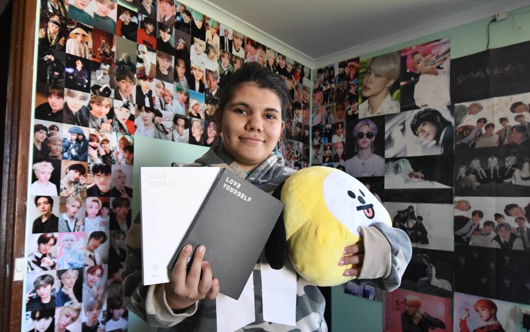 ROOM FOR ONE MORE: Mikayla Nixon with a small selection of her K-pop and BTS merchandise. Photo: JUDE KEOGH.