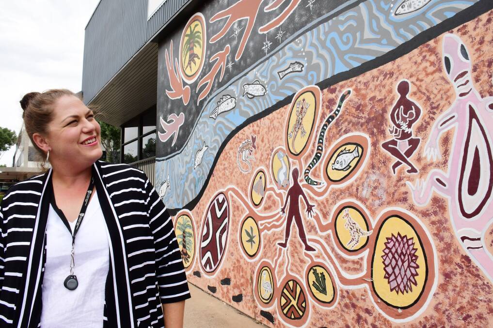 DEADLY ART: Nikki Roberts admires a Wiradjuri mural by Lewis Burns outside Dubbo's Macquarie Regional Library. Photo: BELINDA SOOLE.