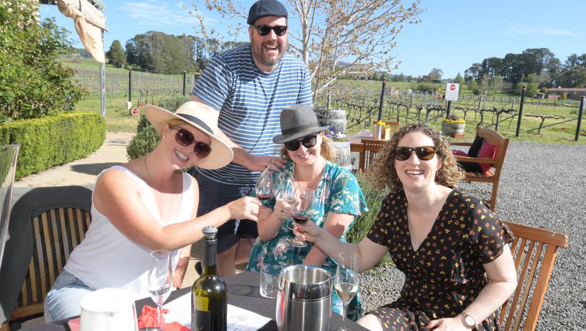 SUNNY DAYS: Claudia James, Luke Hanley, Amelia Hawkins and Cassie Lowry enjoying the blue skies at Dindima winery. Photo: JUDE KEOGH.