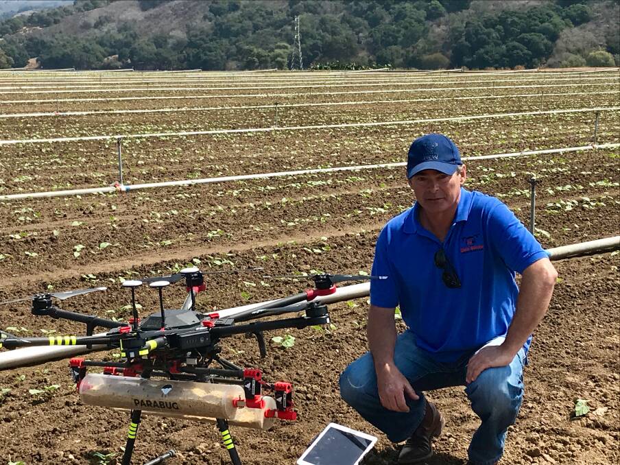 HIGH AND MIGHTY: David Pearce in California with a Parabug drone, which releases millions of mites onto vineyards. Photo: SUPPLIED. 