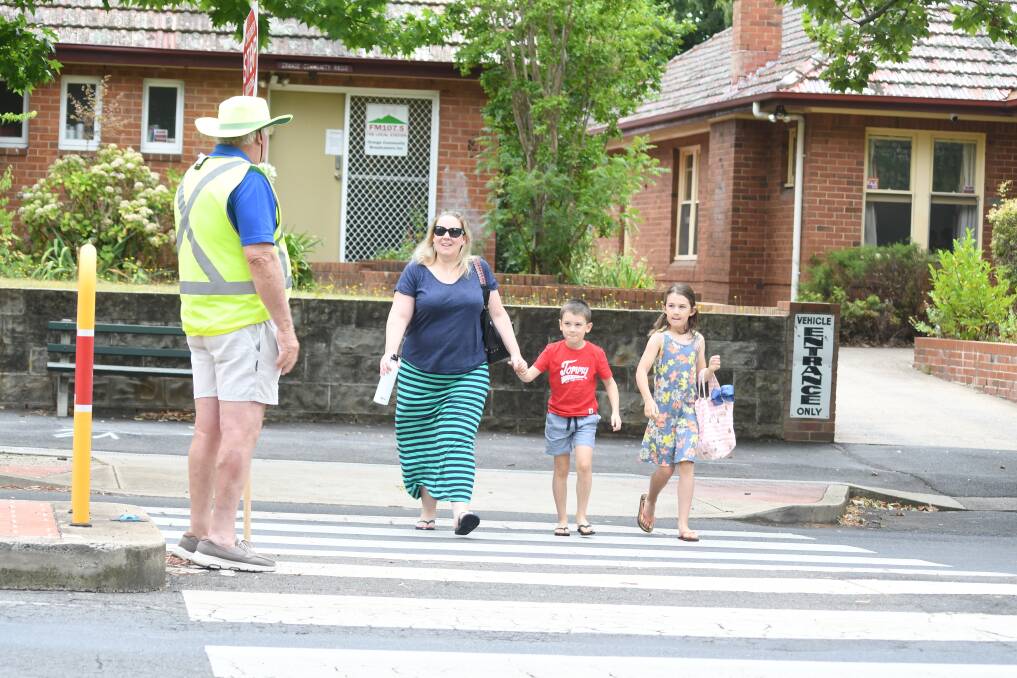 SPEED LIMIT: Kelly, Thomas and Ellie Walker crossing safely on Kite St on Wednesday. Photo: JUDE KEOGH.