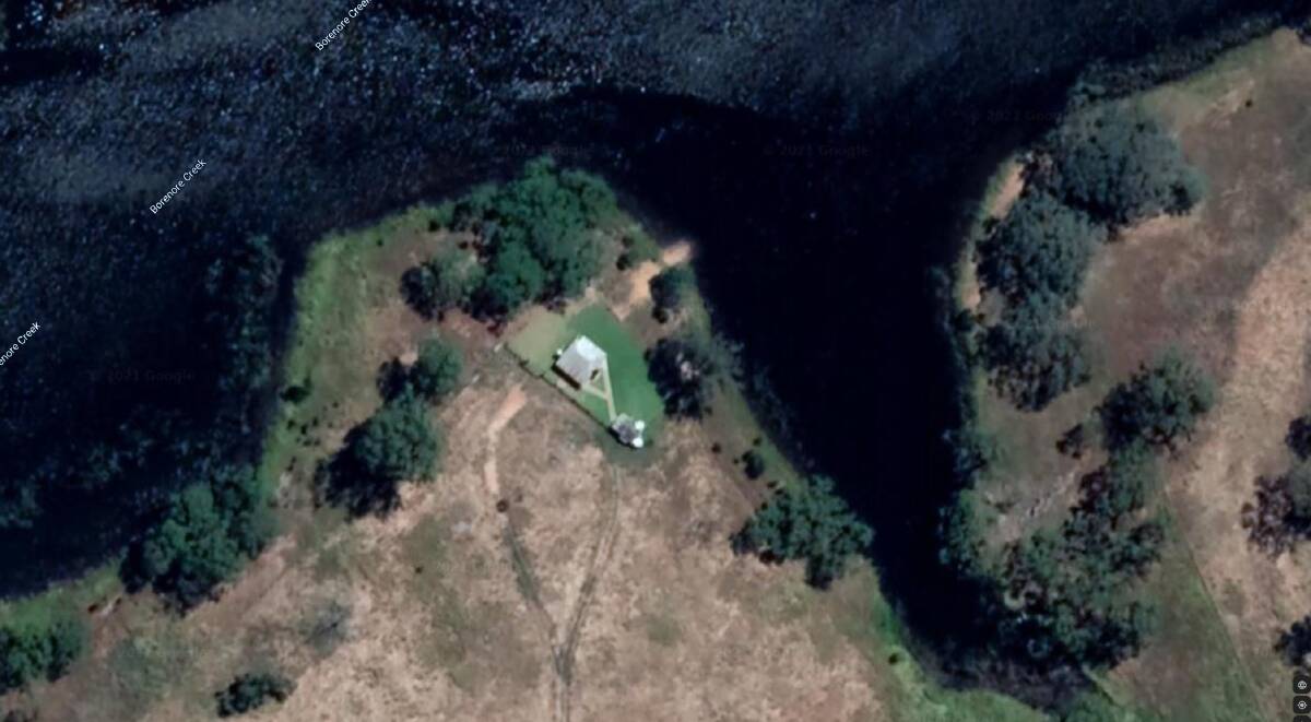 LAKESIDE LIVING: The cottage perched on the edge of Borenore Dam was believed to have been there since 2017. Photo: GOOGLE EARTH.