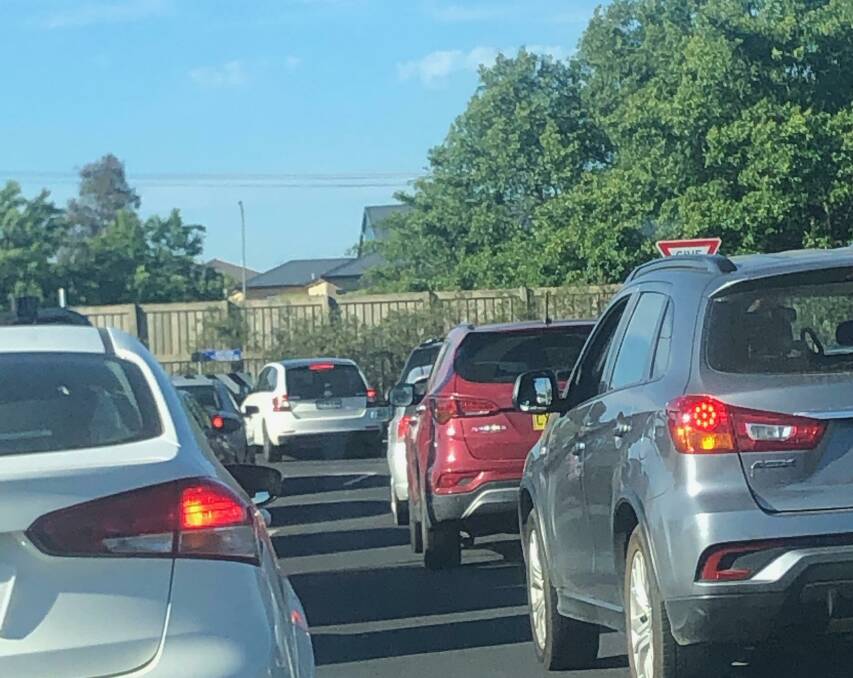 BEDLAM: A white car (centre) is left dangling across the Northern Distributor at Anson Street this week during peak hour traffic chaos, as the driver attempts to turn left and then right into Telopea Way. Photo: RUBY GRACE. 